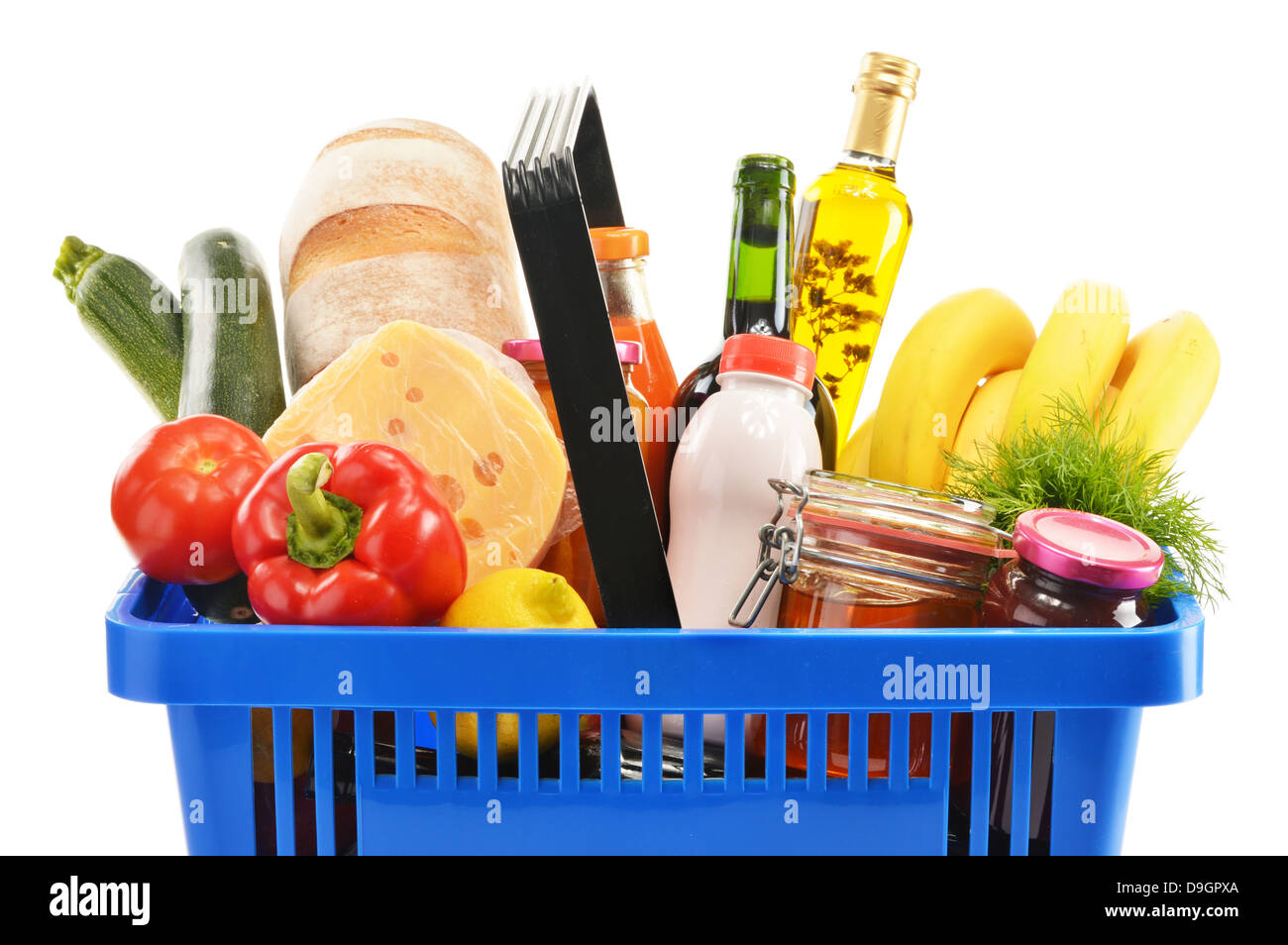 Plastic shopping basket with variety of grocery products isolated on white Stock Photo