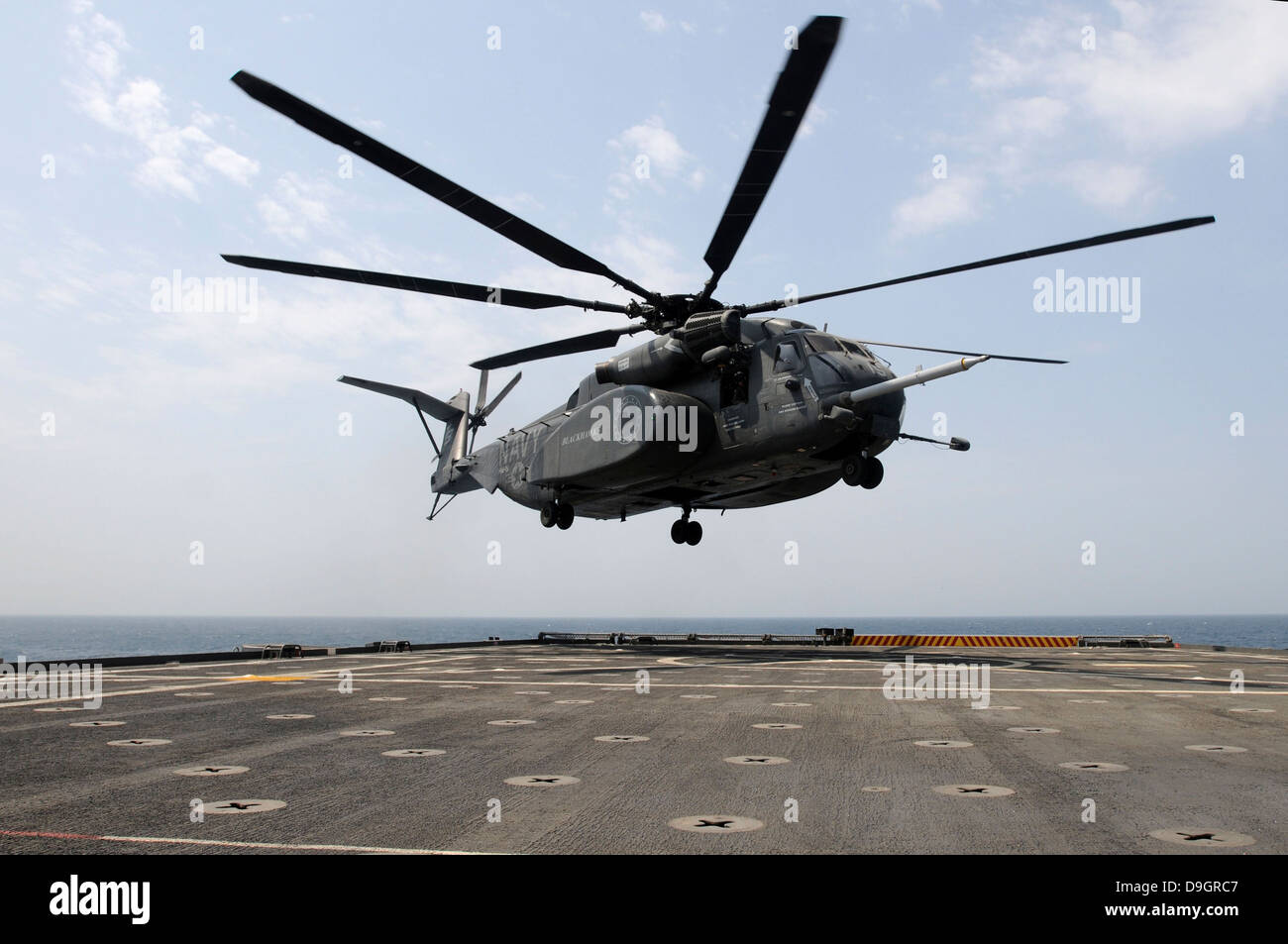 An MH-53E Sea Dragon prepares to land on the flight deck aboard USS Ponce. Stock Photo