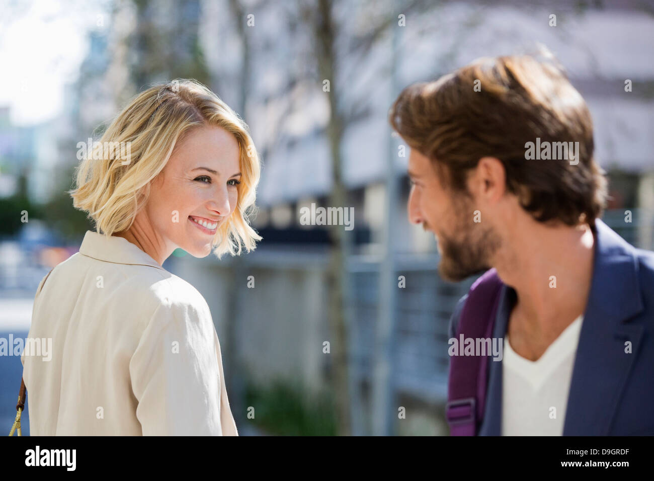 Man and woman smiling at each other Stock Photo - Alamy