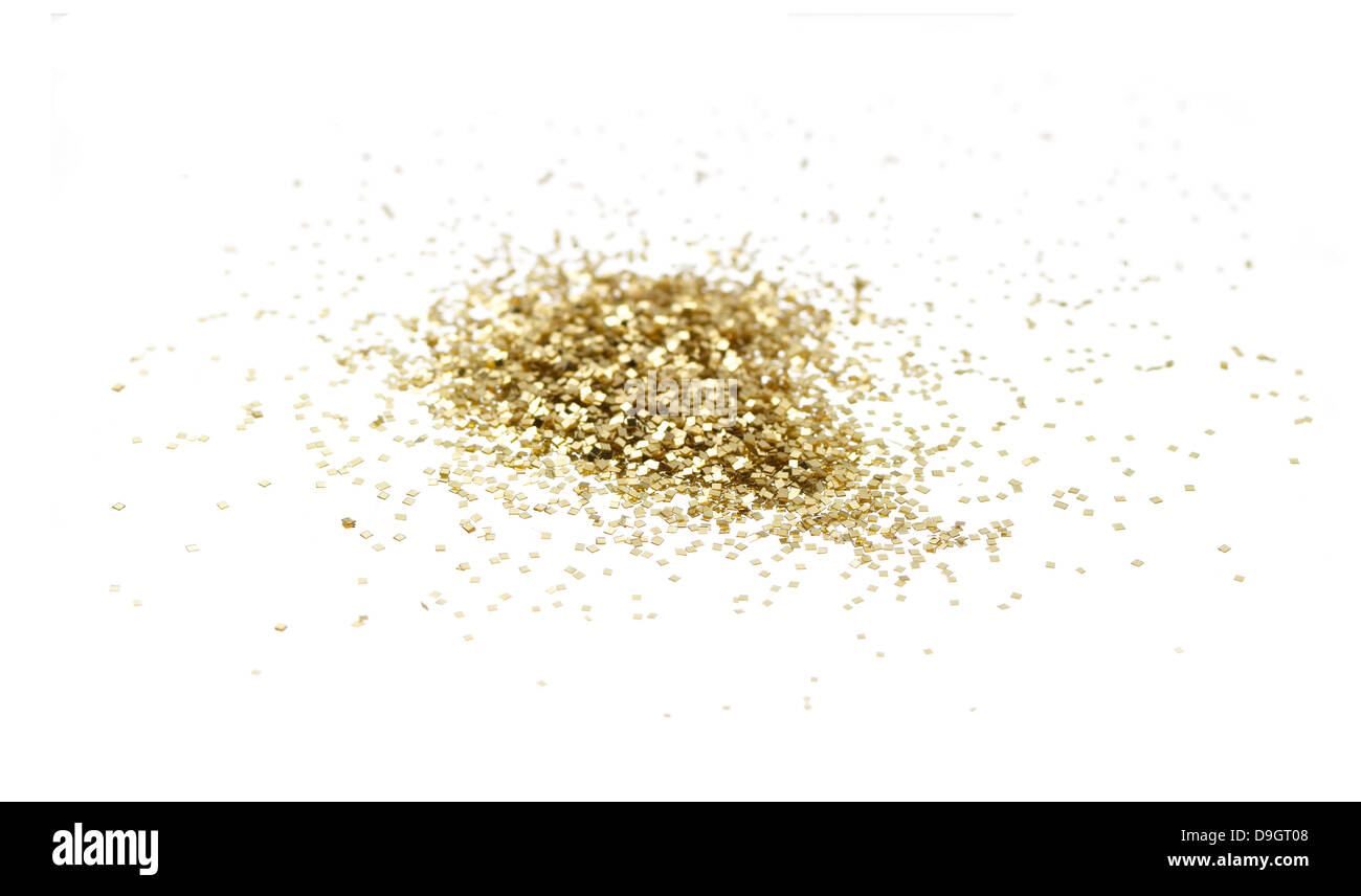 loose pile of gold glitter cut out onto a white background Stock Photo