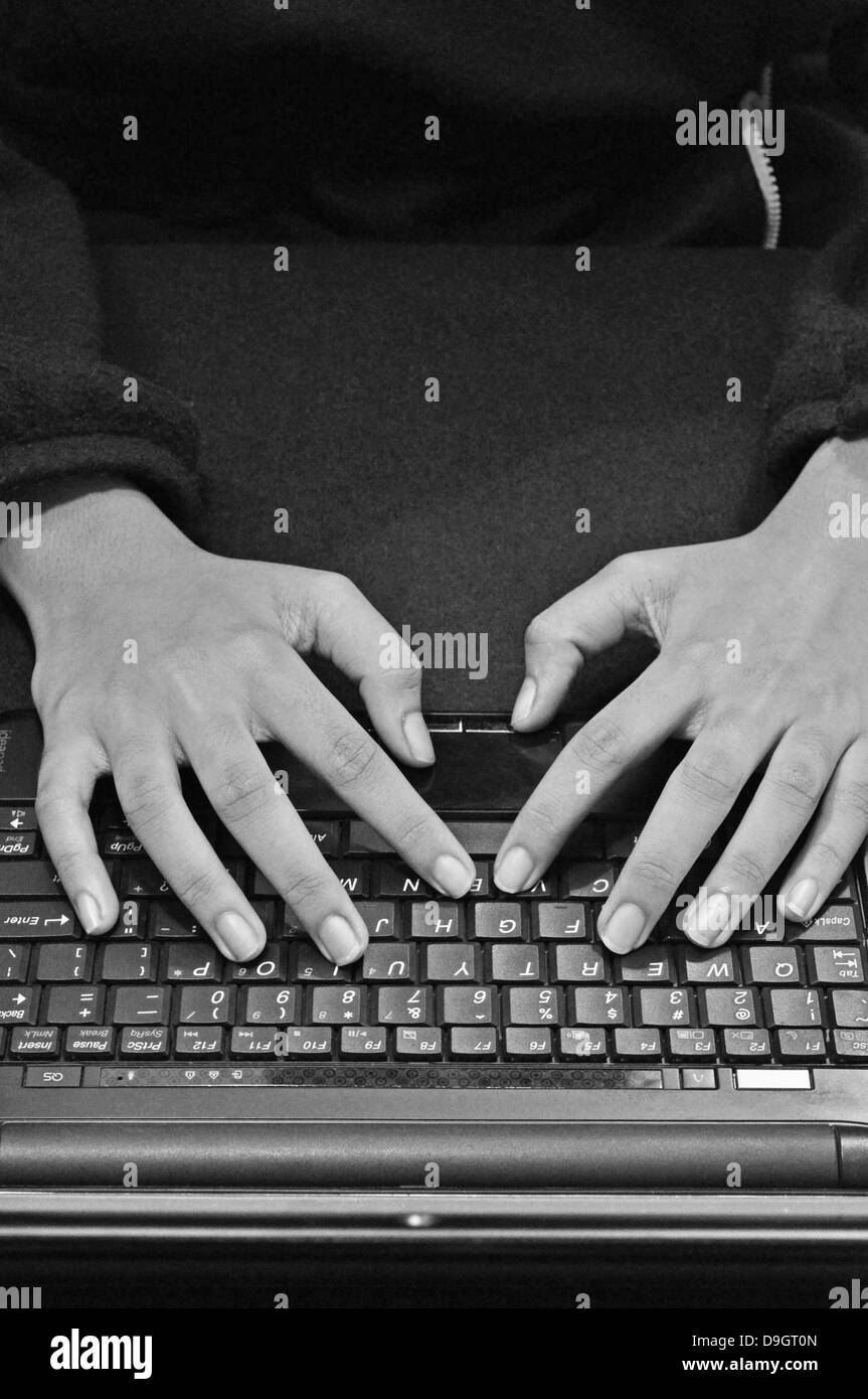 Typing on computer keyboard Stock Photo