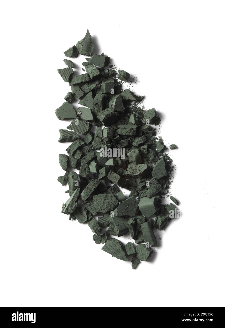 blue green eyeshadow loose powder pile cut out onto a white background Stock Photo