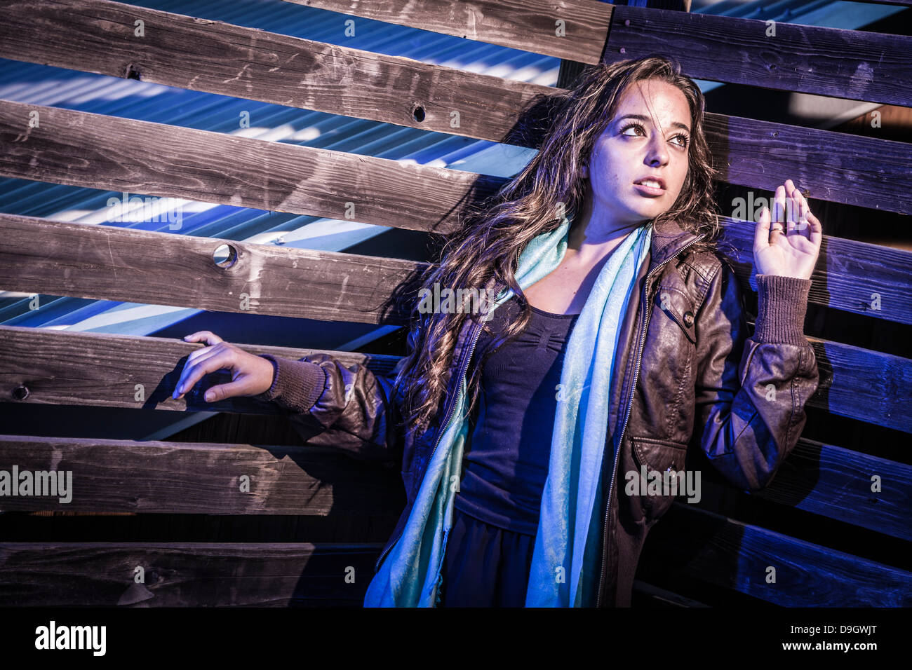 Frightened Pretty Young Woman in Dark Scary Walkway at Night. Stock Photo