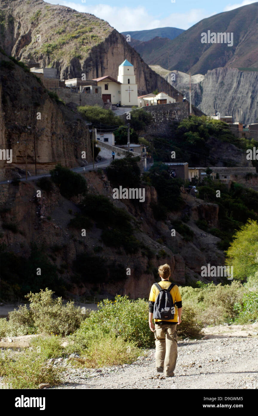 Iruya. A tourist walks along the riverbed to the village of Iruya, village is visible in the background. Stock Photo