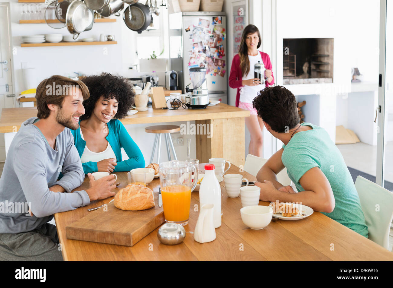 Friends at a dining table Stock Photo - Alamy