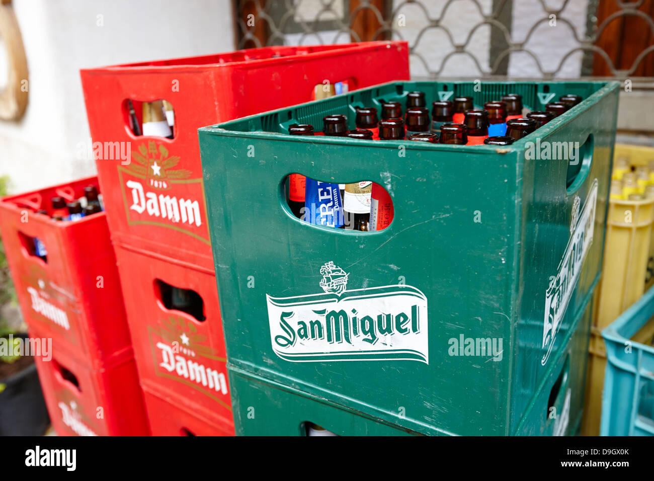 crates of empty beer bottles for recycling outside a small local bar in