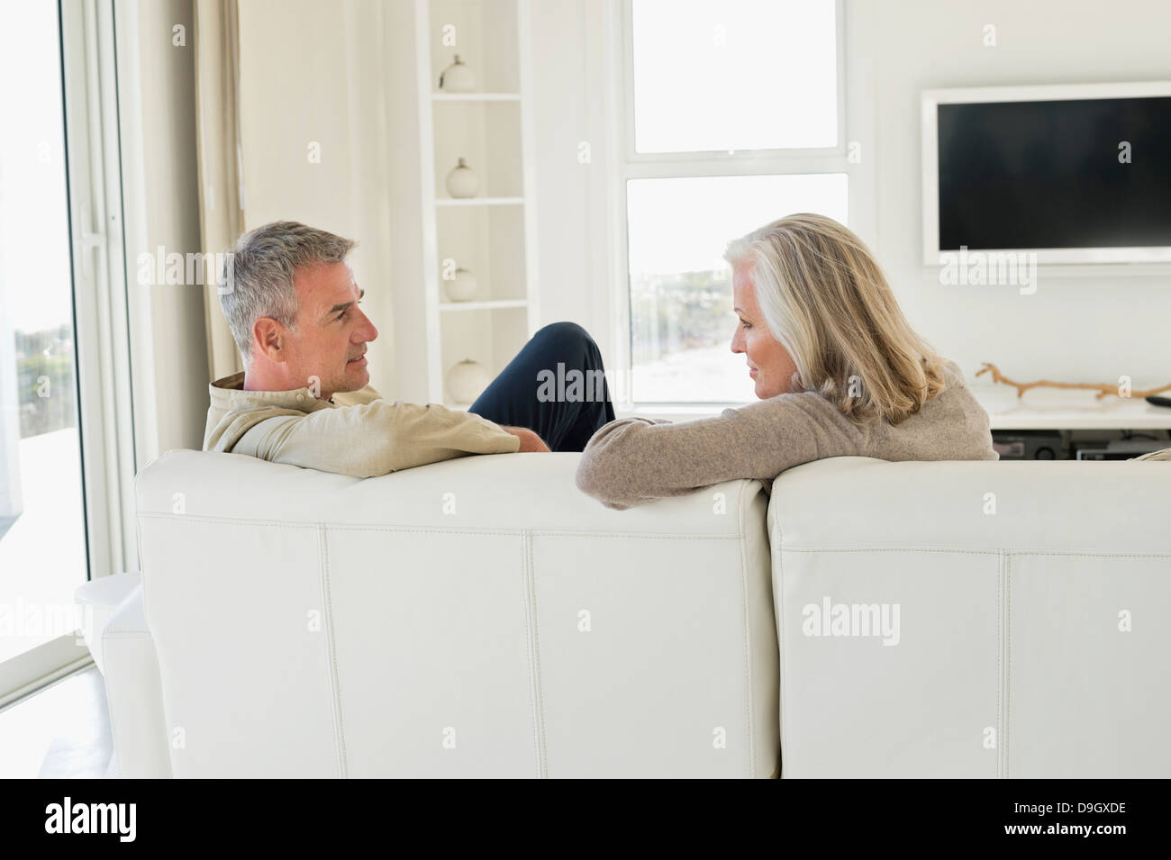 Couple sitting on couch man hi-res stock photography and images - Alamy
