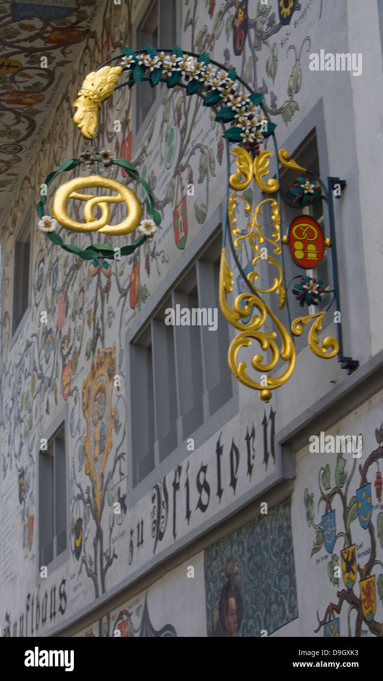 store sign with golden Brezl on old facade in Luzern, Switzerland Stock Photo