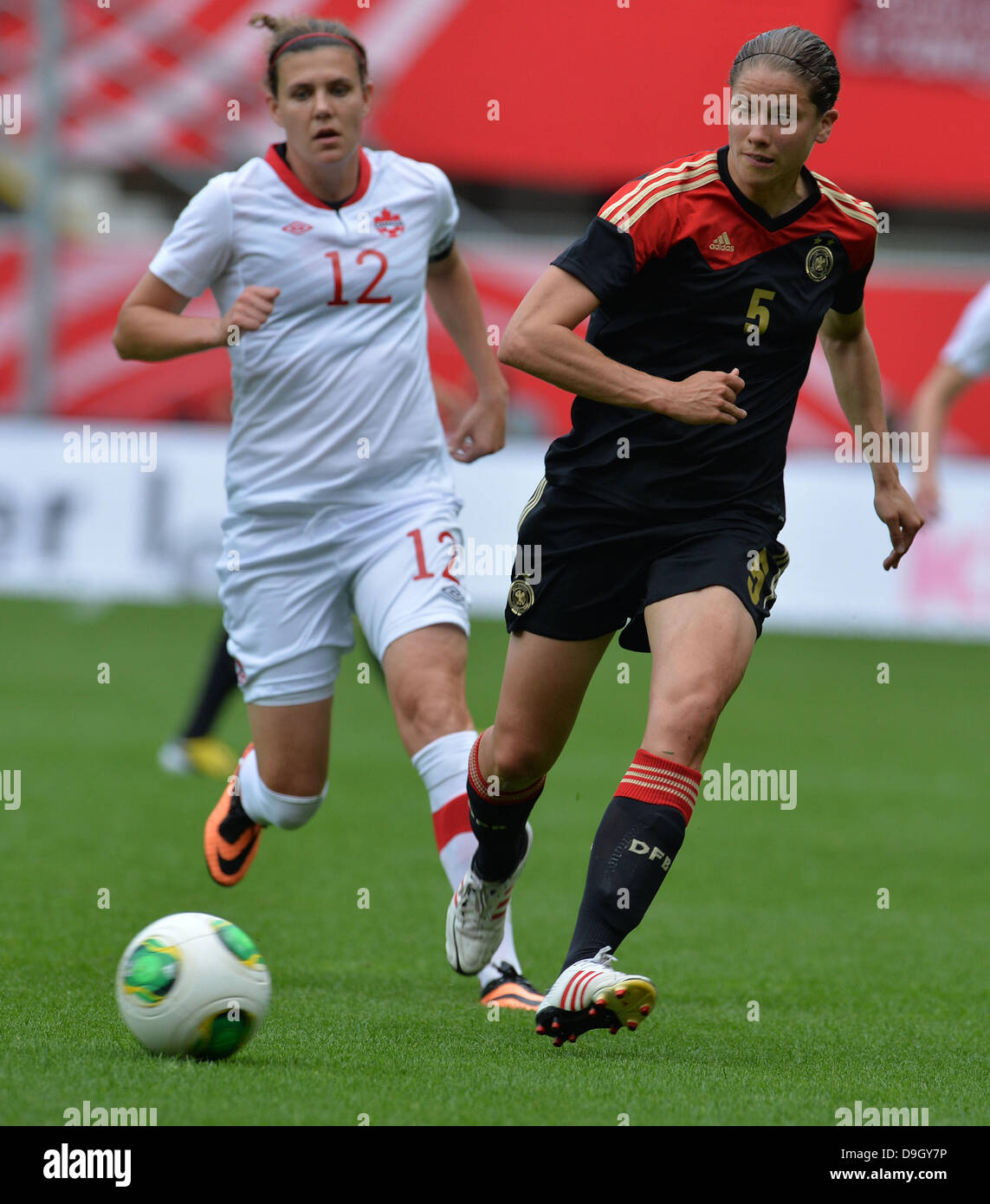 Germany's Annike Krahn (L) vies for the ball with Canada's Christine Sinclair in the women's soccer match Germany vs Canada at Benteler-Arena in Paderborn, Germany, 19 June 2013. Photo: CARMEN JASPERSEN Stock Photo