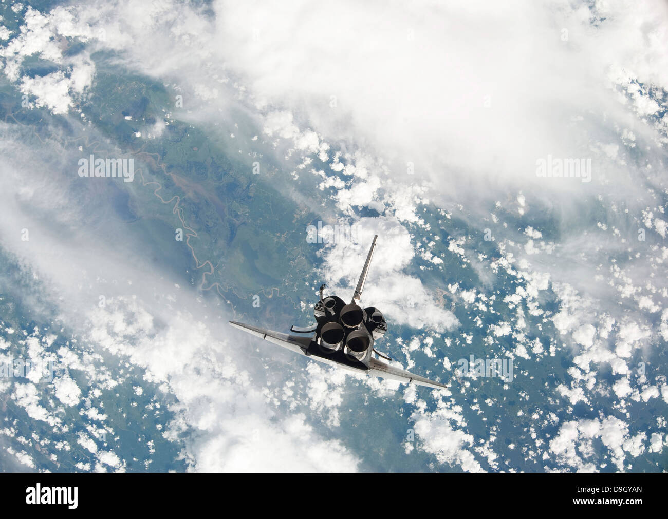 Rear view of the three main engines of space shuttle Discovery as the shuttle approaches the International Space Station. Stock Photo