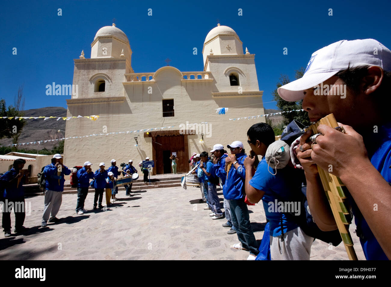 Groups sikuris playing in front the church of Tilcara. Stock Photo