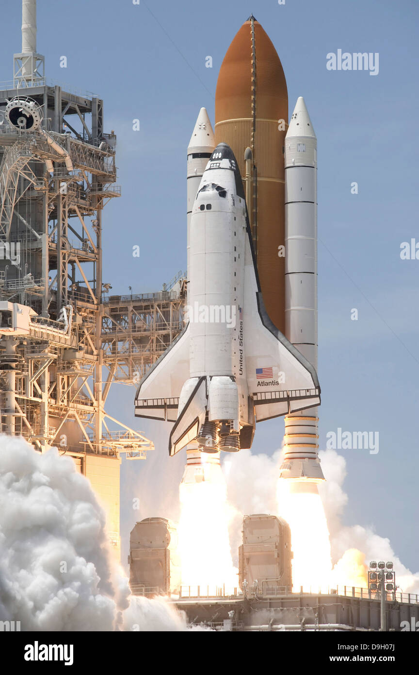 Space shuttle Atlantis' twin solid rocket boosters ignite to propel the spacecraft off Kennedy Space Center's Launch Pad 39A. Stock Photo