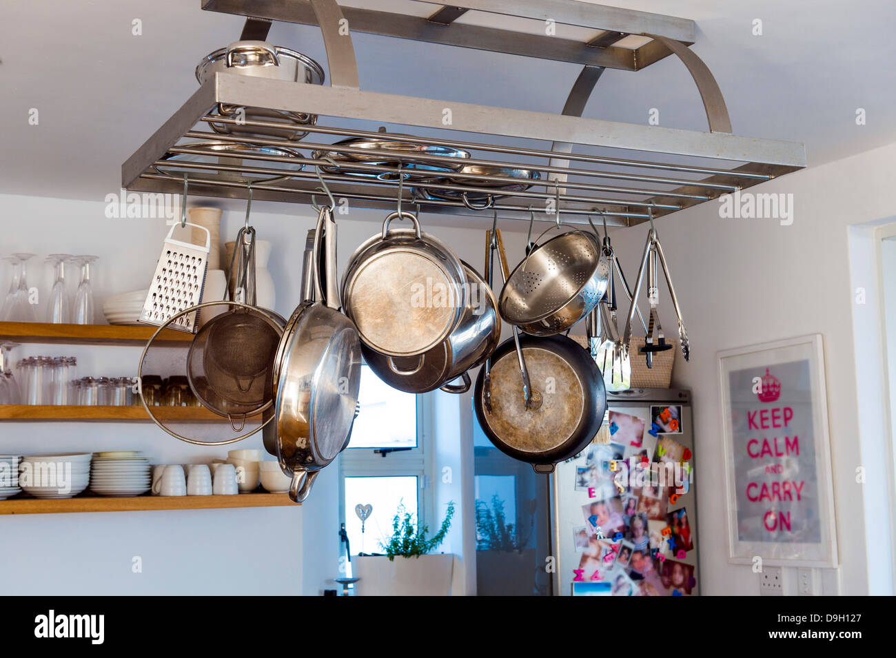Cooking utensils hanging in the kitchen Stock Photo Alamy