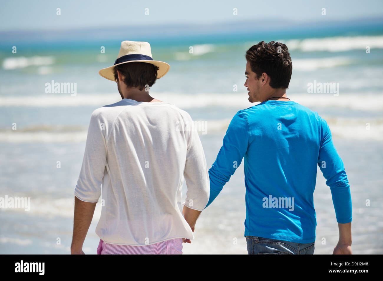 Two men walking on the beach Stock Photo - Alamy