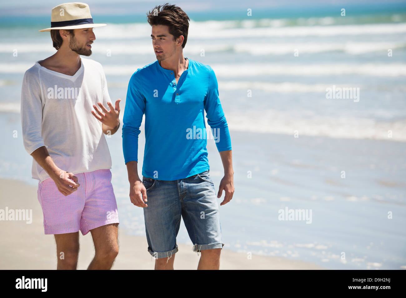 Two men walking on the beach Stock Photo - Alamy