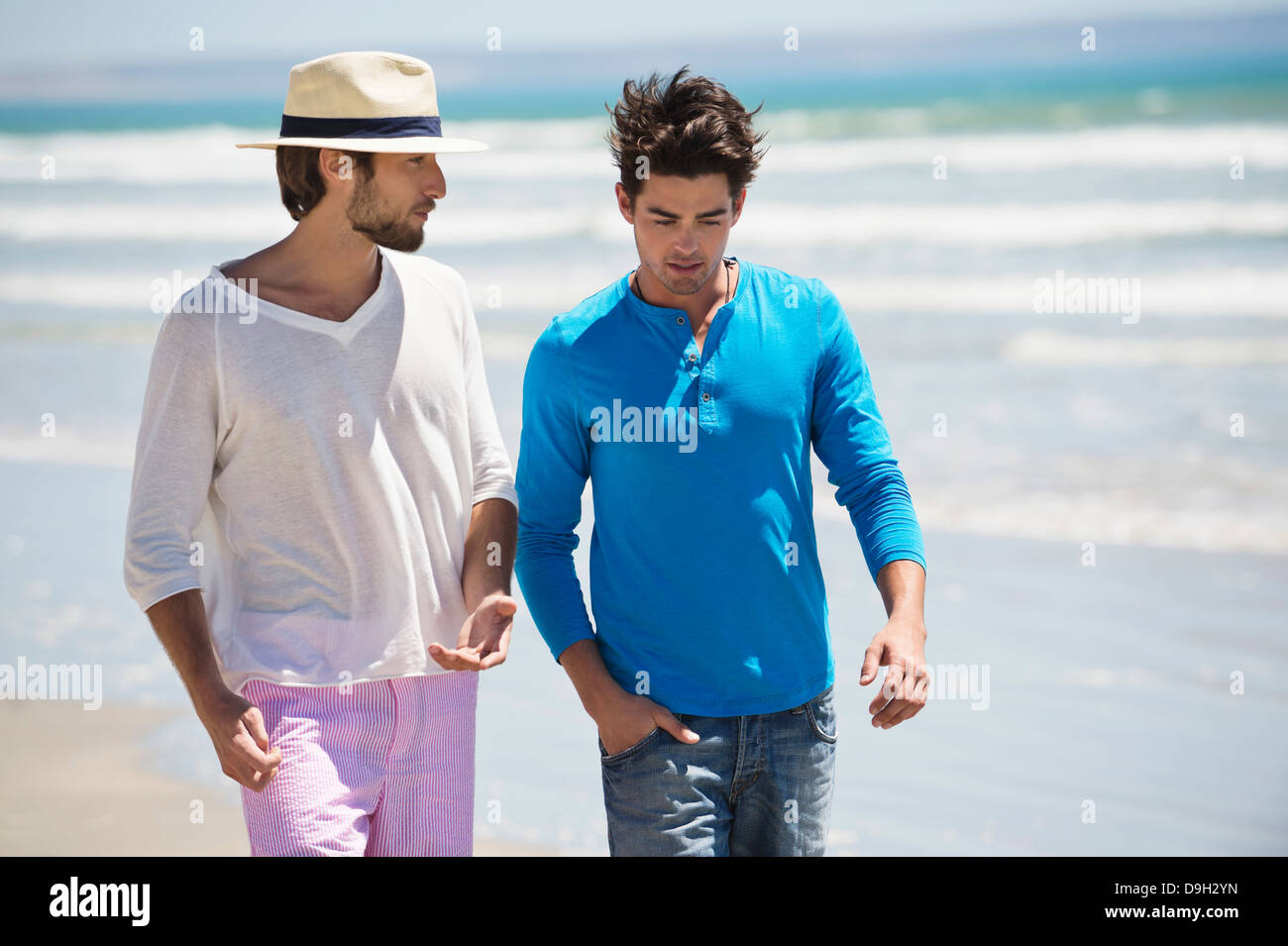 Two men walking on the beach Stock Photo - Alamy