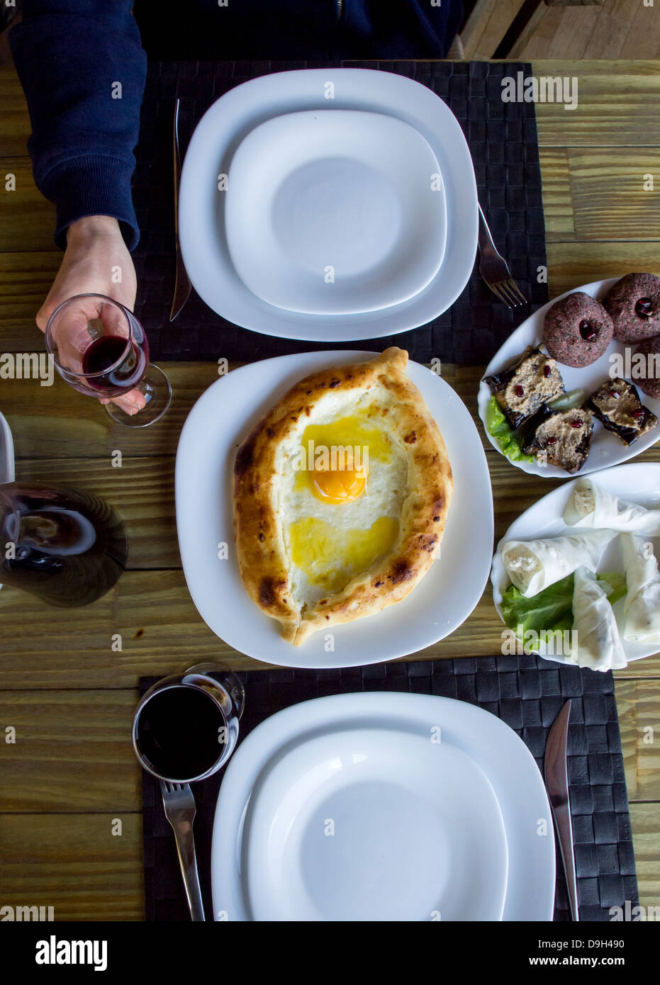 Georgian cuisine: bread with cheese and egg called adjaruli khachapuri, phkali and nadughi rolled in sulguni cheese. Stock Photo