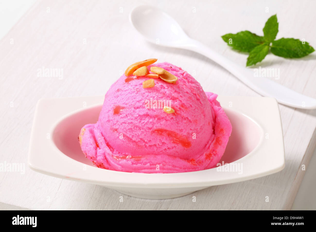 Scoop of pink ice cream on a dessert plate Stock Photo