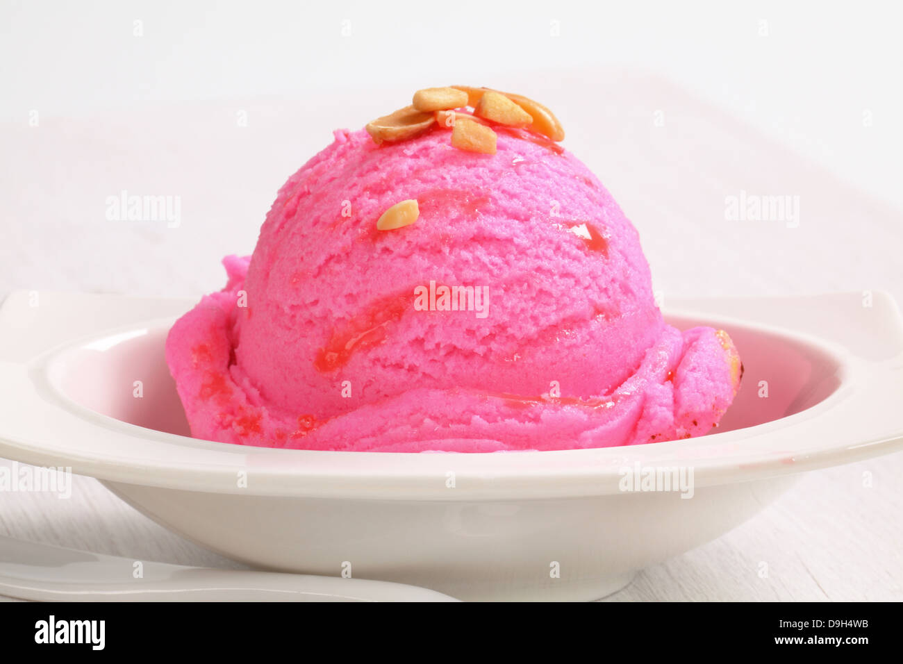 Scoop of pink ice cream on a dessert plate Stock Photo