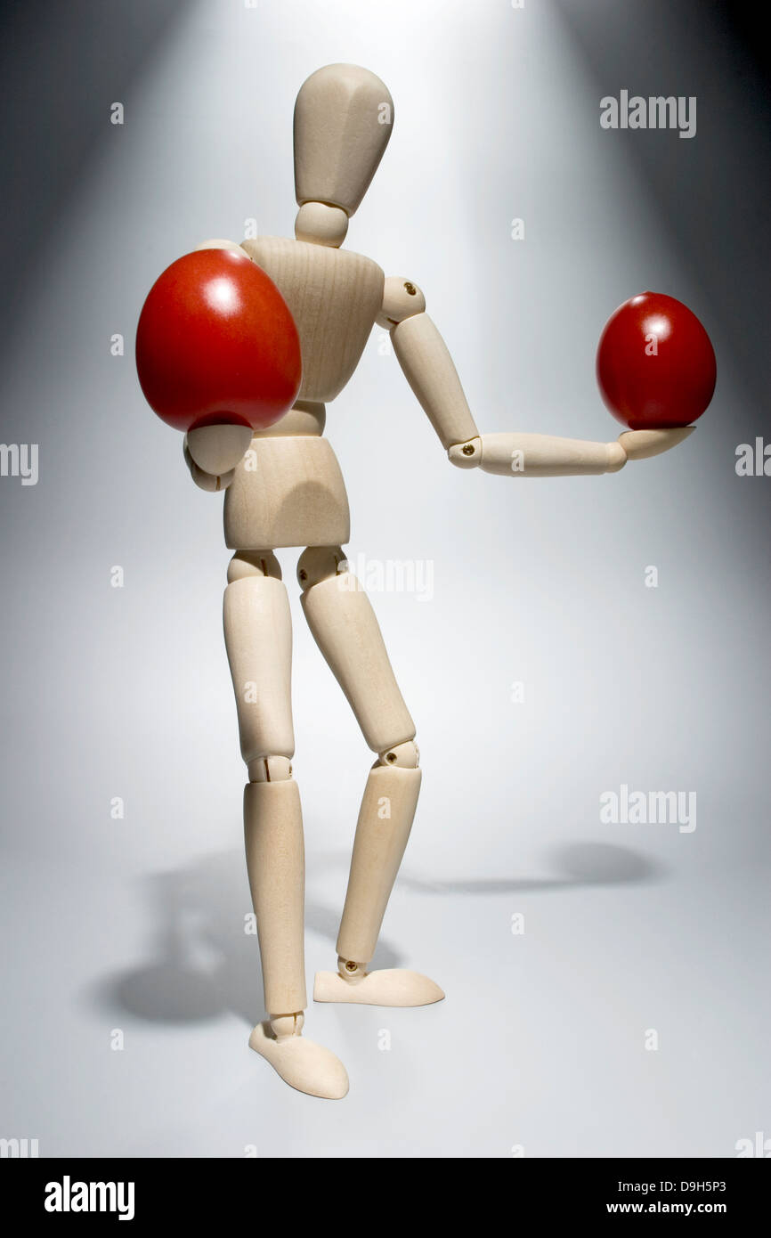 Limb doll with tomatoes Stock Photo