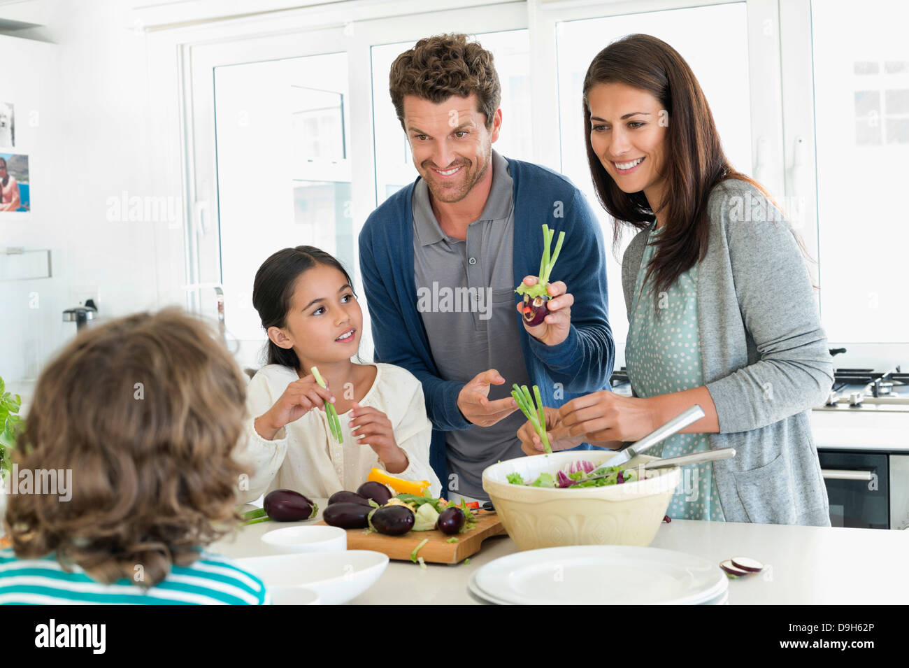 Family preparing food in the kitchen Stock Photo Alamy