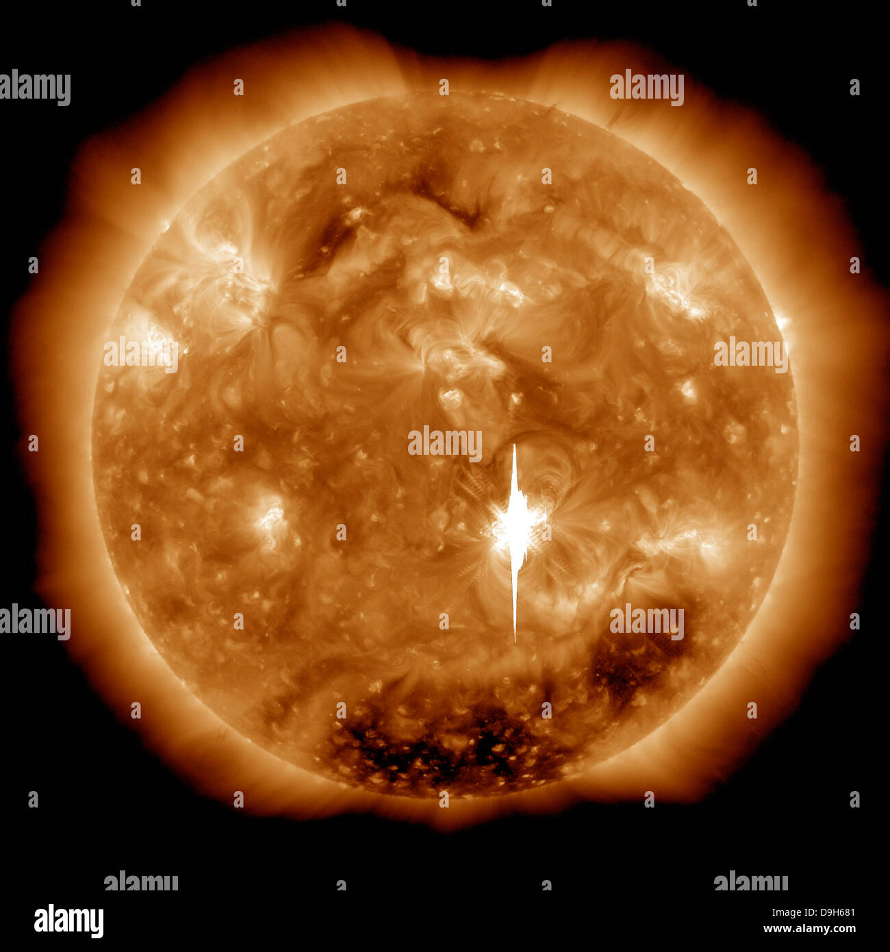 A massive X-class solar flare erupts on the Sun. Stock Photo