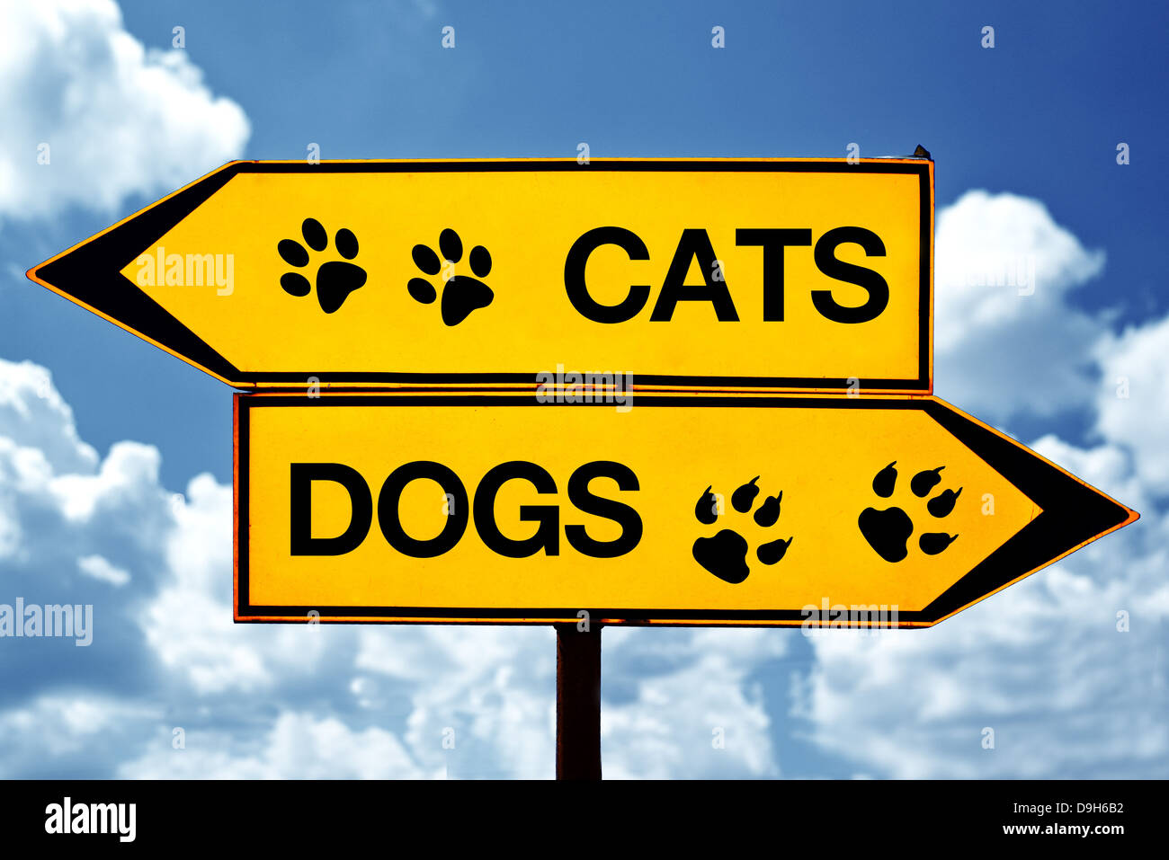 Cats or dogs, opposite signs. Two opposite signs against blue sky background. Stock Photo