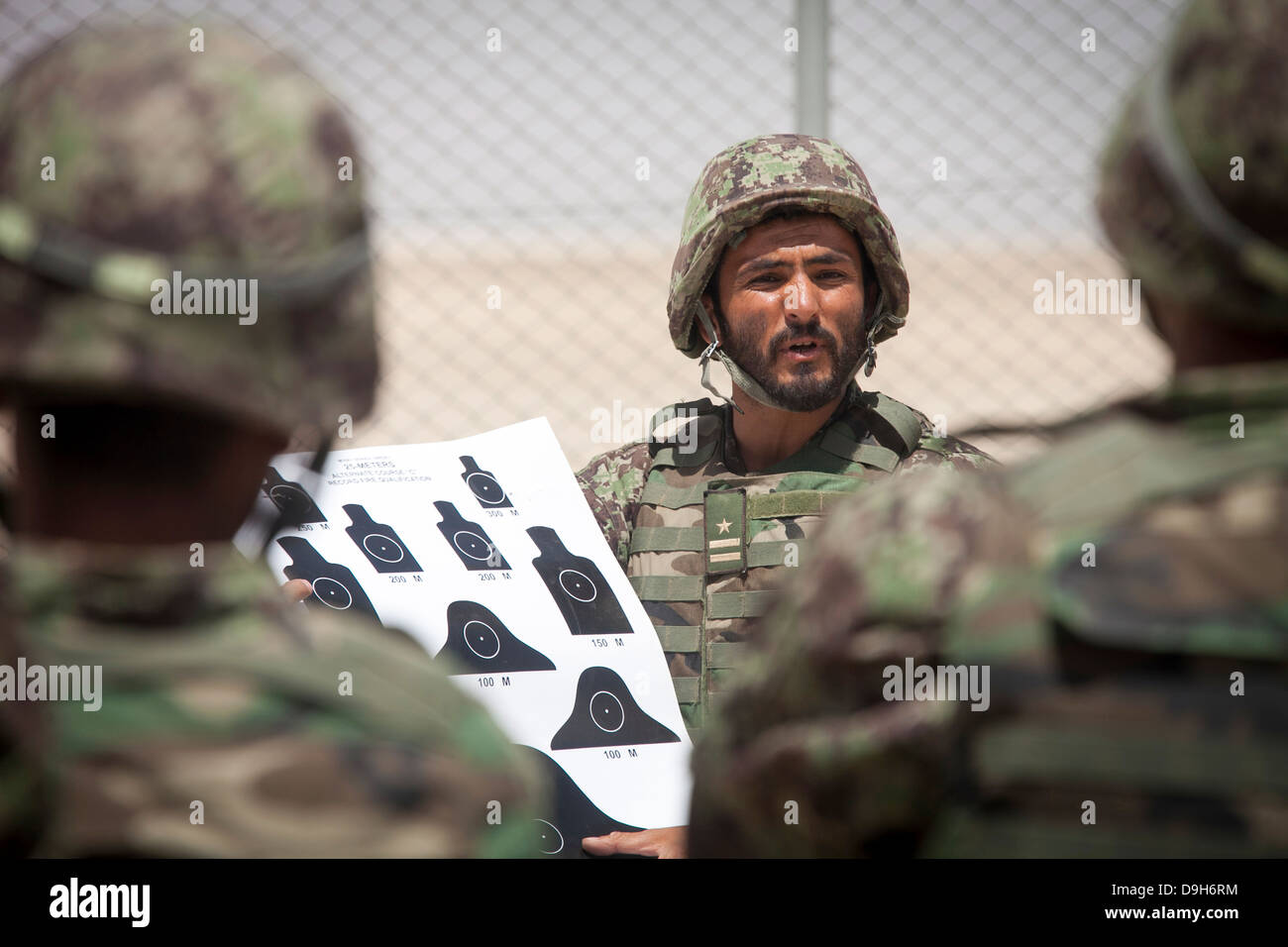 An Afghan National Army soldier with the Kandak Special Operations forces briefs fellow soldiers before a live-fire exercise May 20, 2013 in Camp Shorabak, Afghanistan. Stock Photo