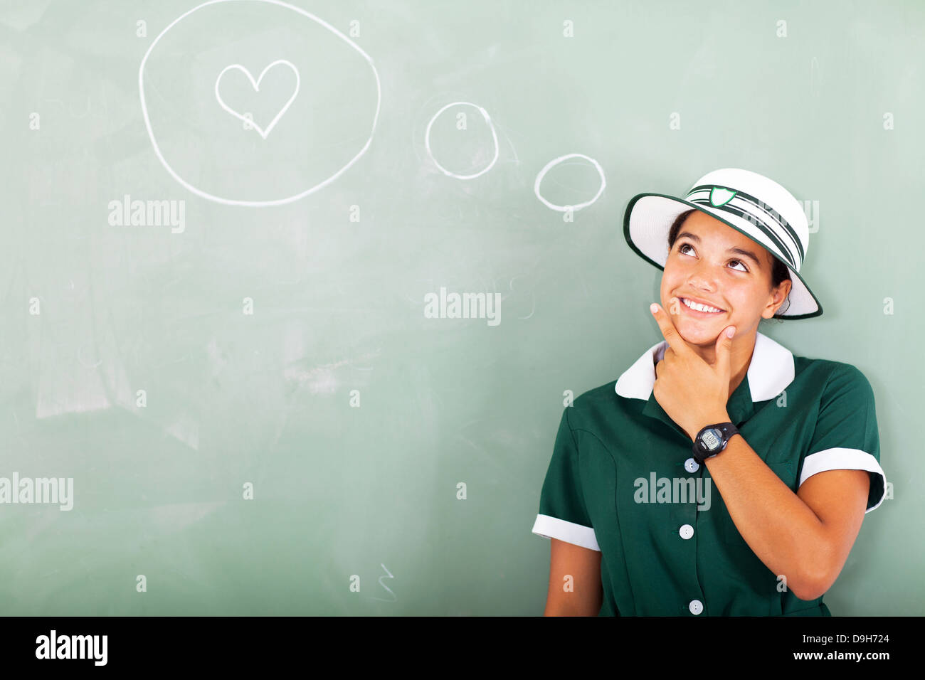 cute high school girl thinking about love in classroom Stock Photo
