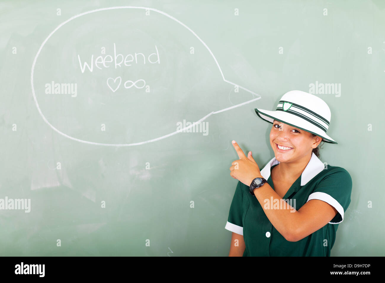 cheerful teenage school girl thinking about the weekend in classroom Stock Photo
