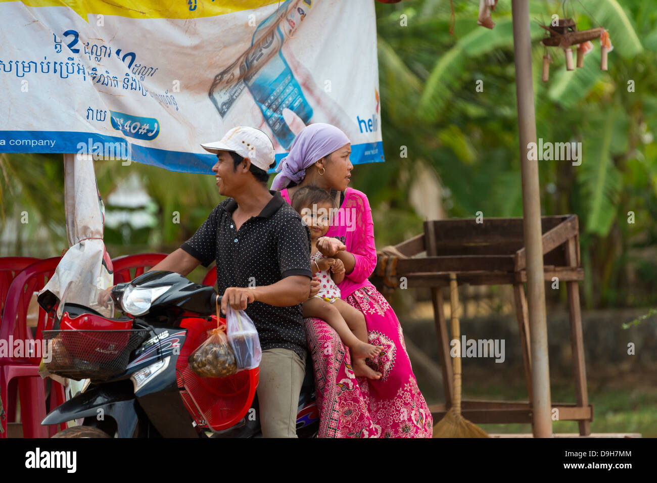 Small Family on a Scooter in the Province of Kampot in Cambodia Stock