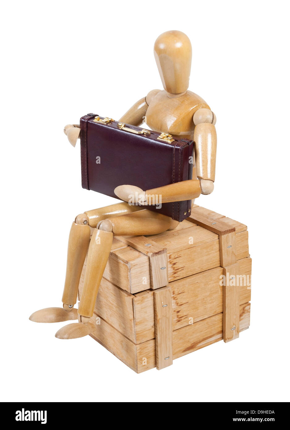 Employee holding briefcase on wooden crate used to protect cargo while being shipped Stock Photo