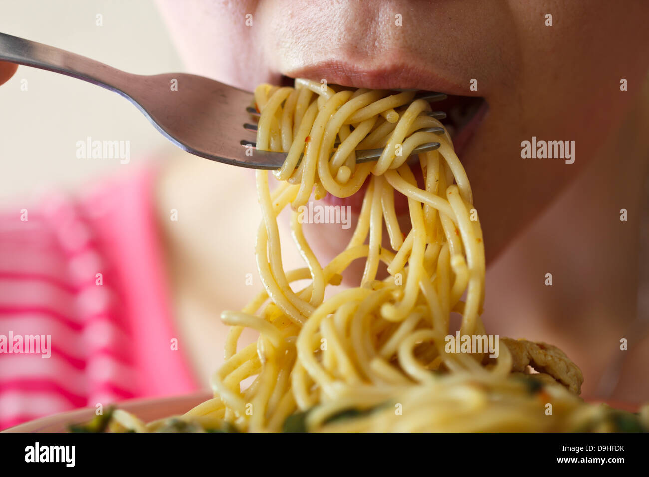 Beautiful young women are eating spaghetti in spicy Stock Photo