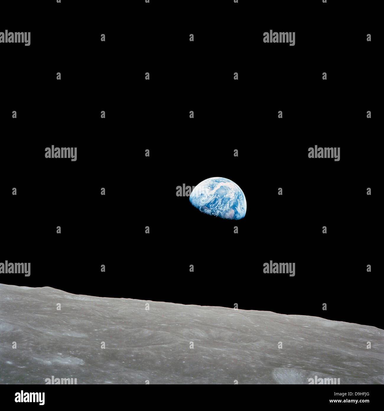 Earth rising above the lunar horizon. Stock Photo