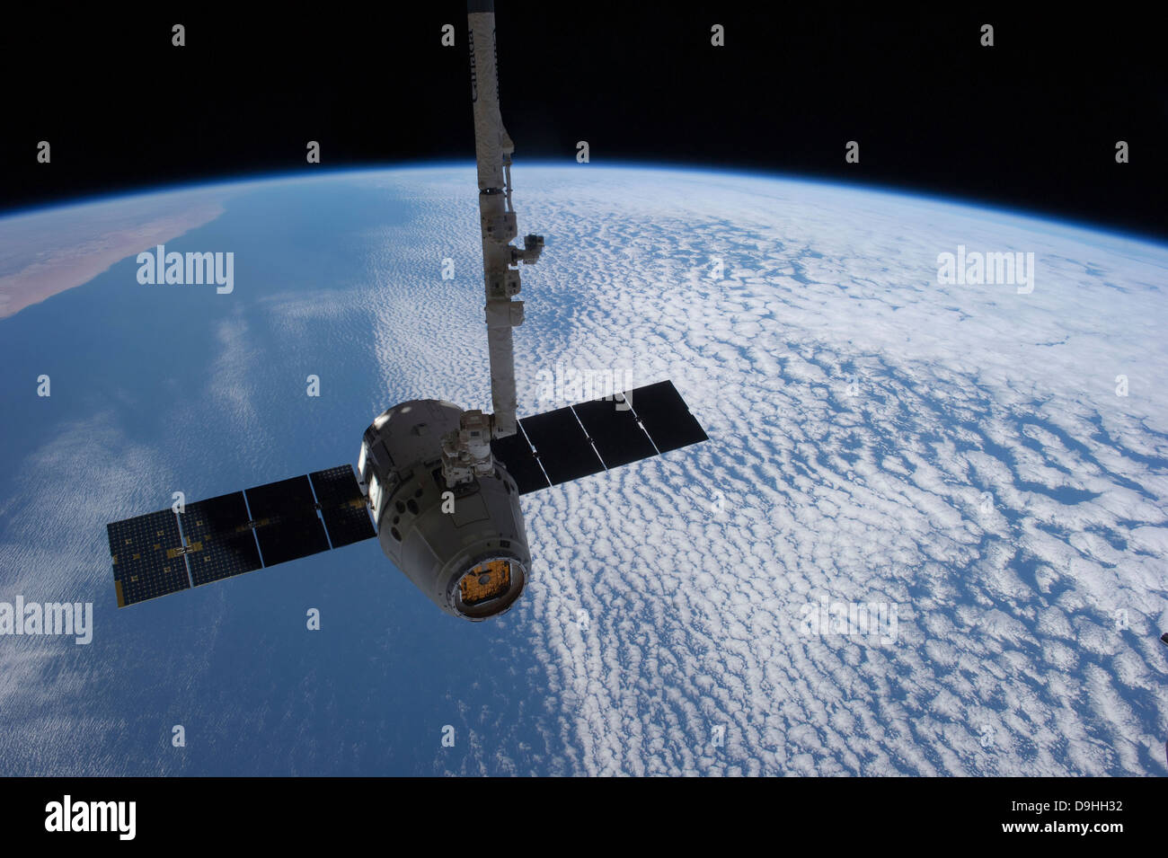 The SpaceX Dragon cargo craft prior to being released from the Canadarm2. Stock Photo