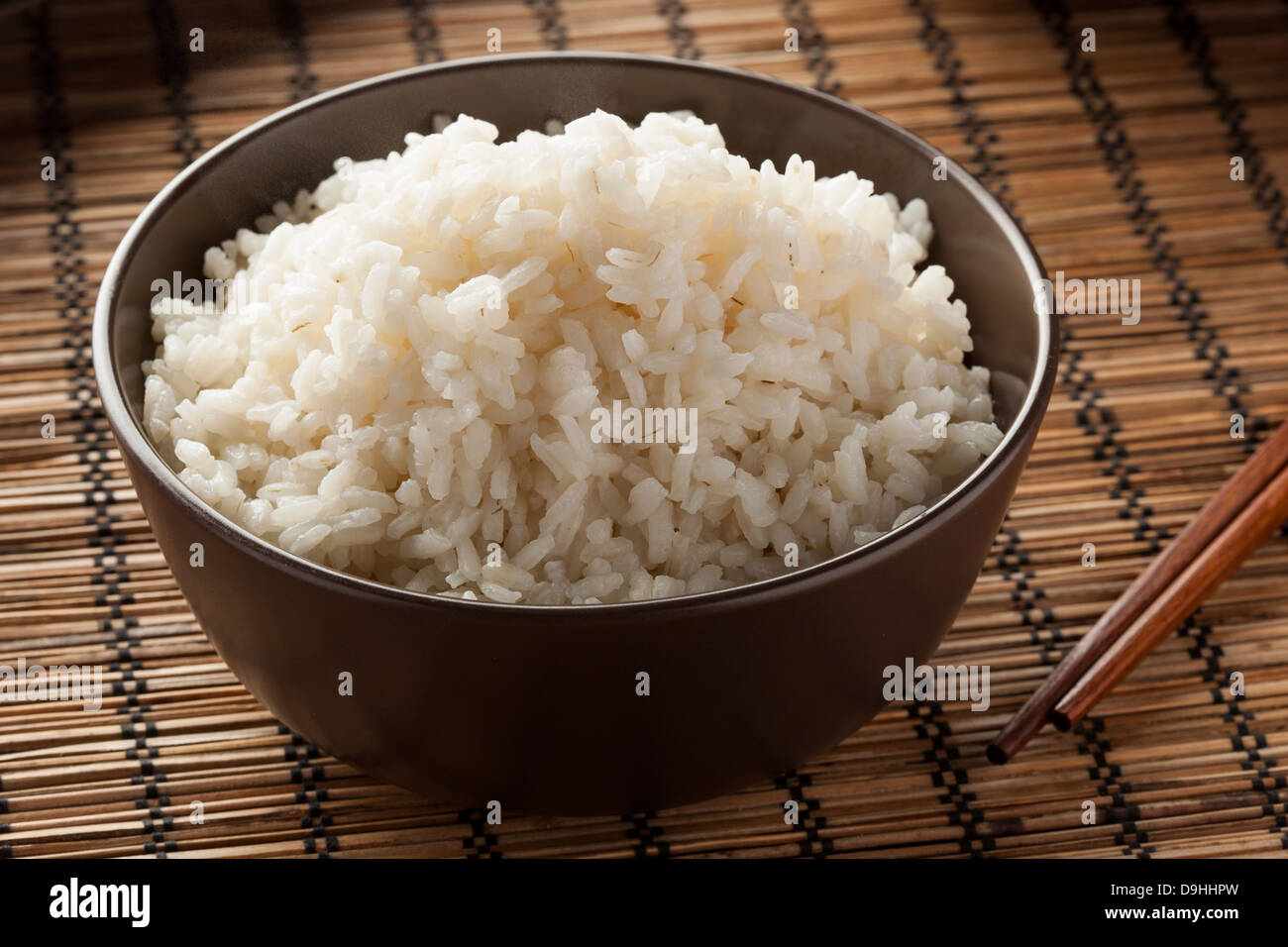 Bowl of Organic White Rice with chop sticks Stock Photo