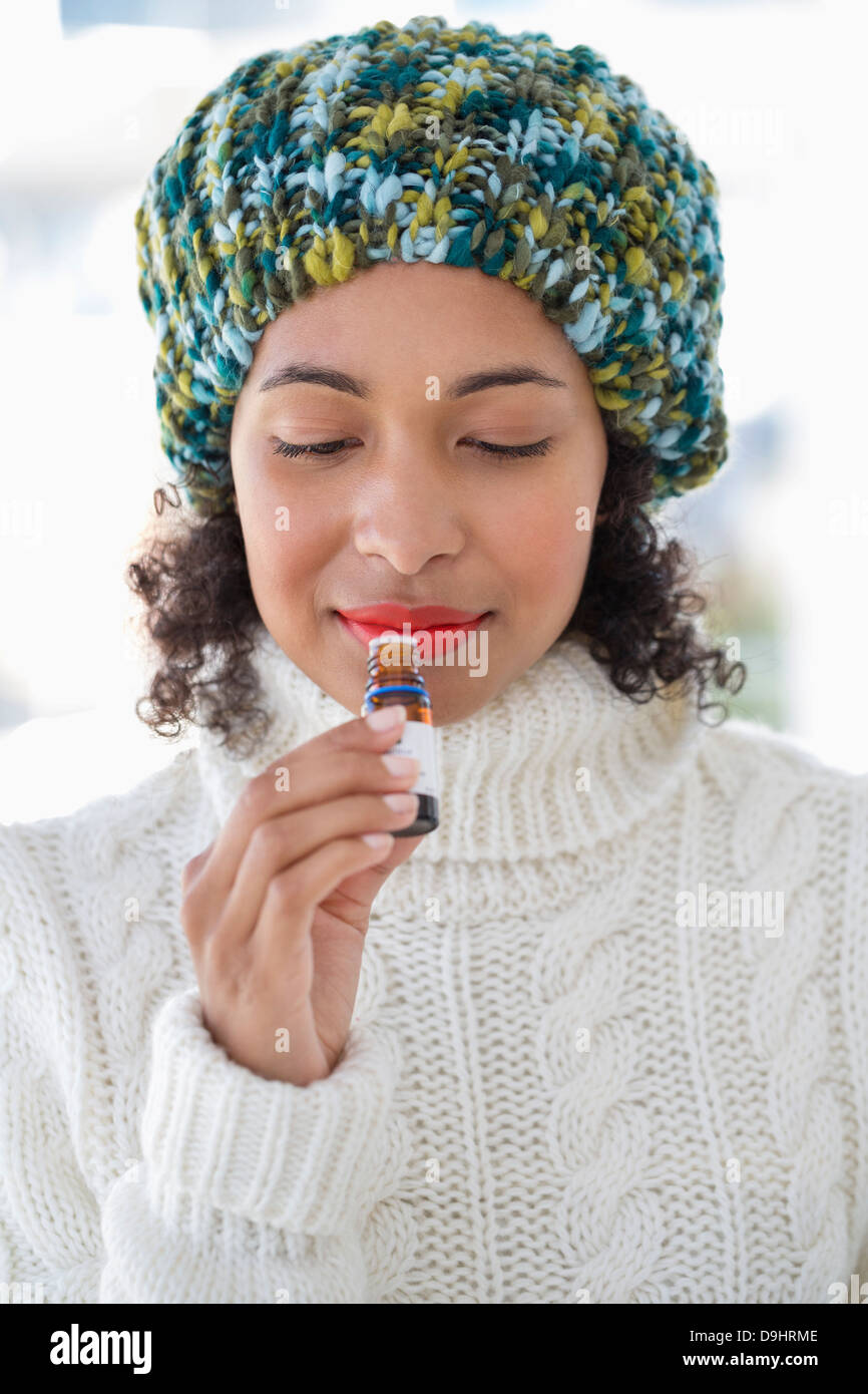 Woman smelling a bottle Stock Photo