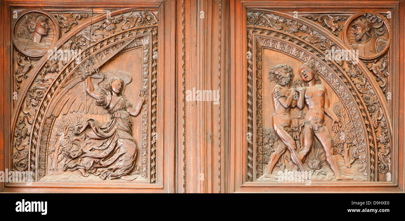 MADRID - MARCH 10: Wooden relief expulsion of Adam and Eva from Paradise scene from indoor gate of Capilla del Obispo Stock Photo