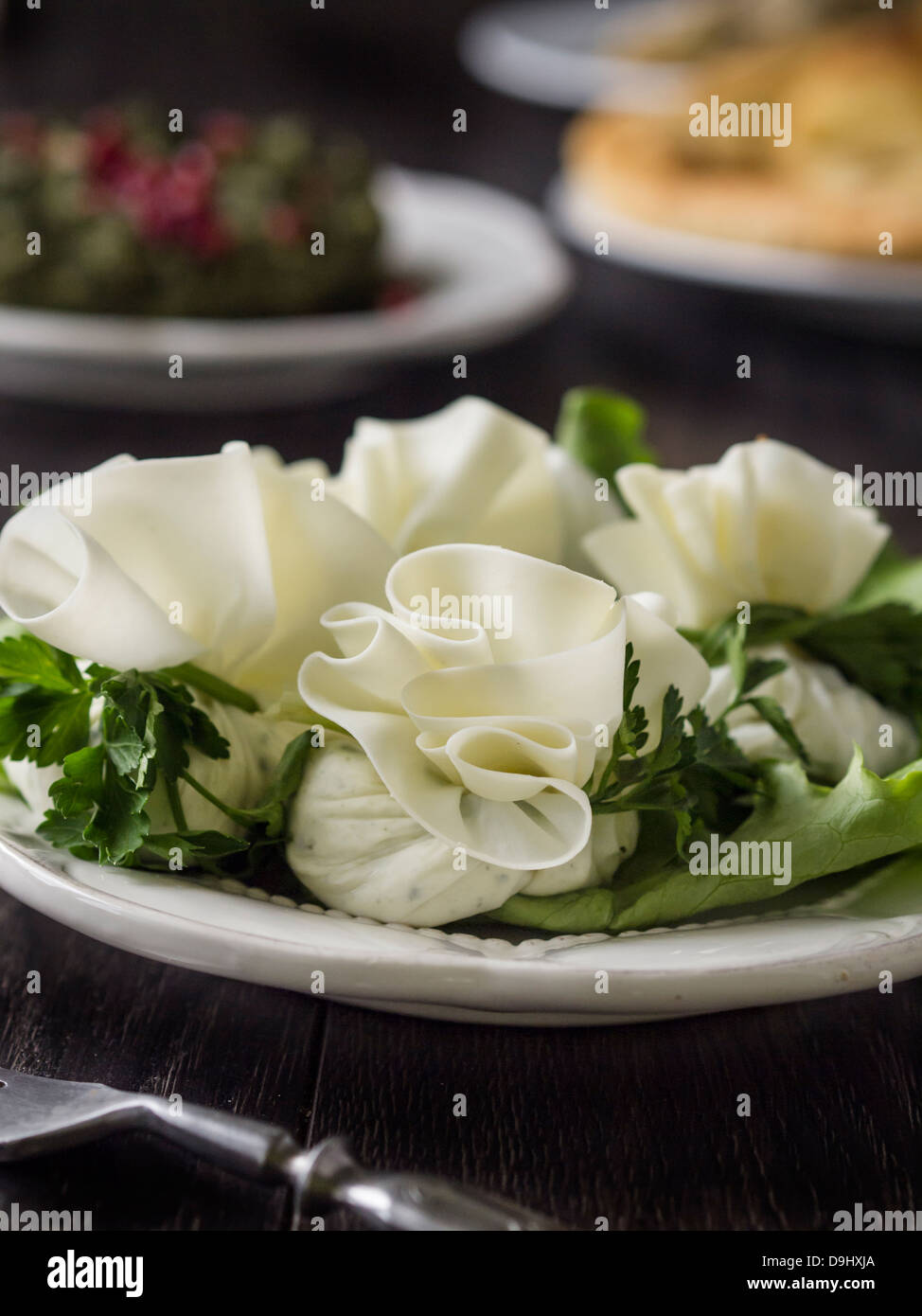 Georgian cuisine: nadughi, dairy product similar to cottage cheese rolled in finely cut sulguni cheese. Stock Photo