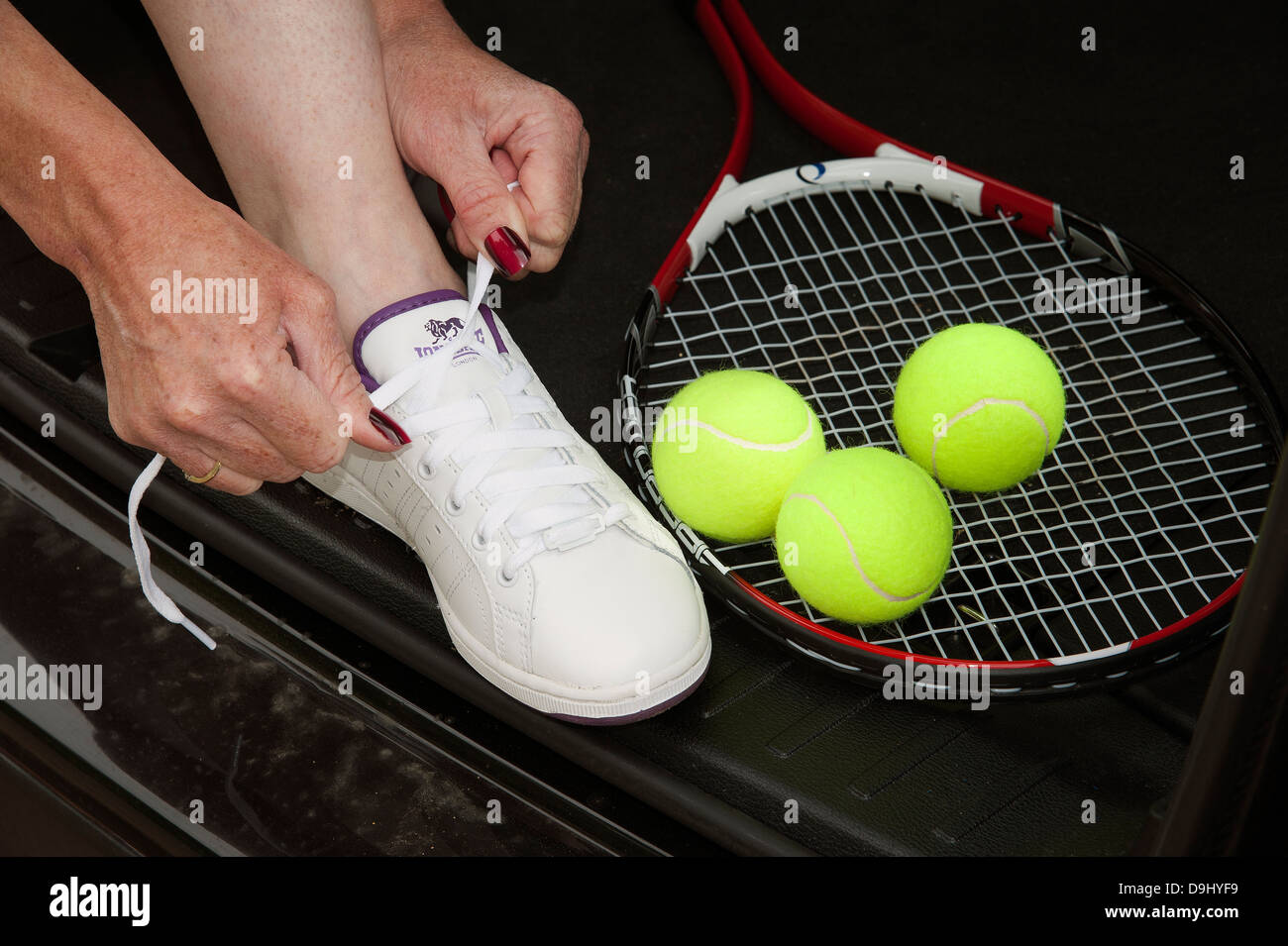 Female tennis player tying shoe lace Stock Photo Alamy