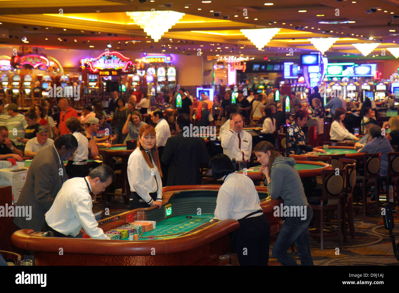 Las Vegas Nevada,The Strip,South Las Vegas Boulevard,Bally's Las Vegas Hotel & Casino,gamble,gambling,gamblers,players,base dealer,craps,tables,Asian Stock Photo