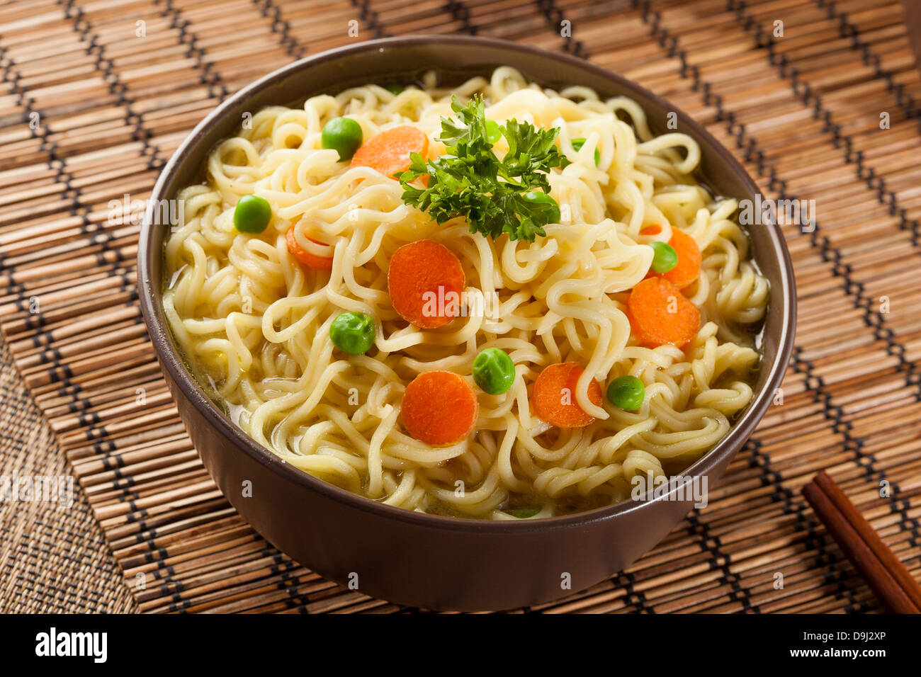 Homemade Quick Ramen Noodles with carrots and peas Stock Photo