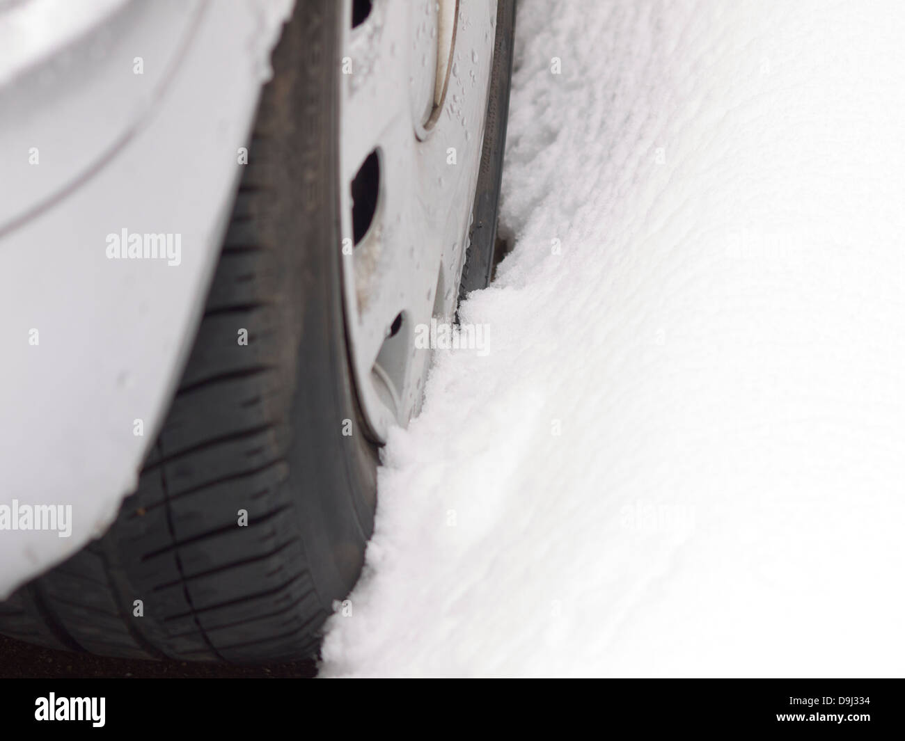 Car tyre stuck in the snow Stock Photo Alamy