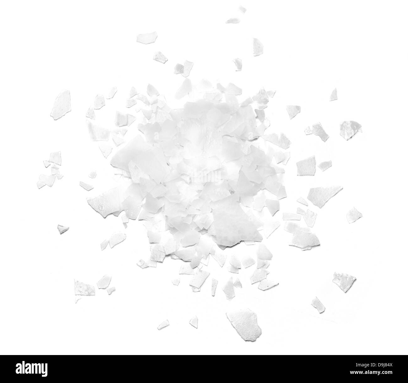 pile of loose white salt flakes  cut out onto a white background Stock Photo