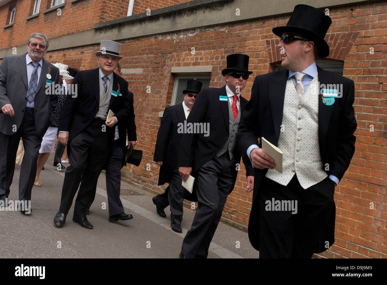 Formally-dressed gentlemen arrive at the racecourse during the annual Royal Ascot horseracing festival in Berkshire, England. Royal Ascot is one of Europe's most famous race meetings, and dates back to 1711. Queen Elizabeth and various members of the British Royal Family attend. Held every June, it's one of the main dates on the English sporting calendar and summer social season. Over 300,000 people make the annual visit to Berkshire during Royal Ascot week, making this Europe’s best-attended race meeting with over £3m prize money to be won. Stock Photo