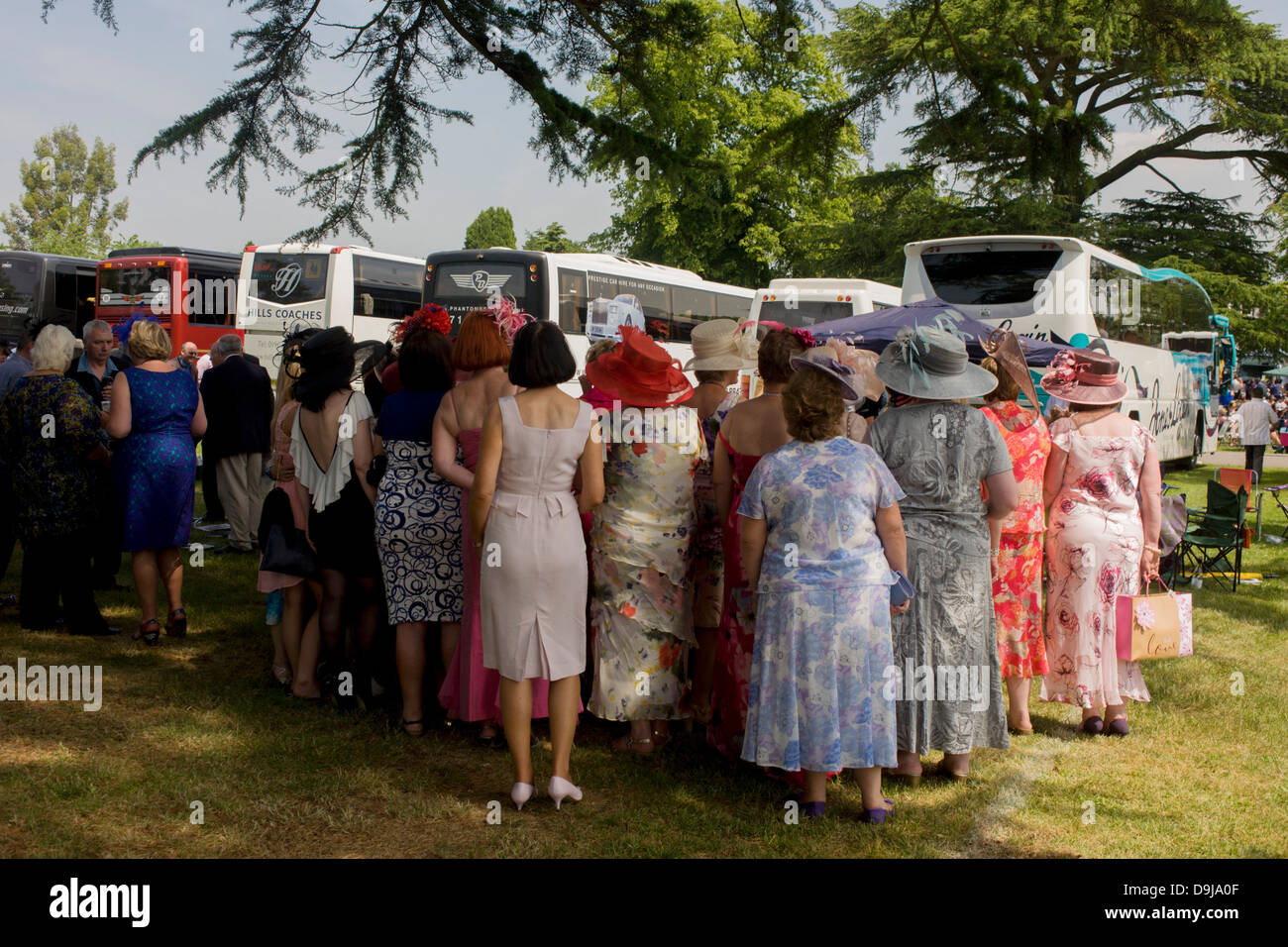 A womens' daytrip group from Wales enjoy a summer's morning, hours before horse racing starts during the annual Royal Ascot festival in Berkshire, England. Royal Ascot is one of Europe's most famous race meetings, and dates back to 1711. Queen Elizabeth and various members of the British Royal Family attend. Held every June, it's one of the main dates on the English sporting calendar and summer social season. Over 300,000 people make the annual visit to Berkshire during Royal Ascot week, making this Europe’s best-attended race meeting with over £3m prize money to be won. Stock Photo