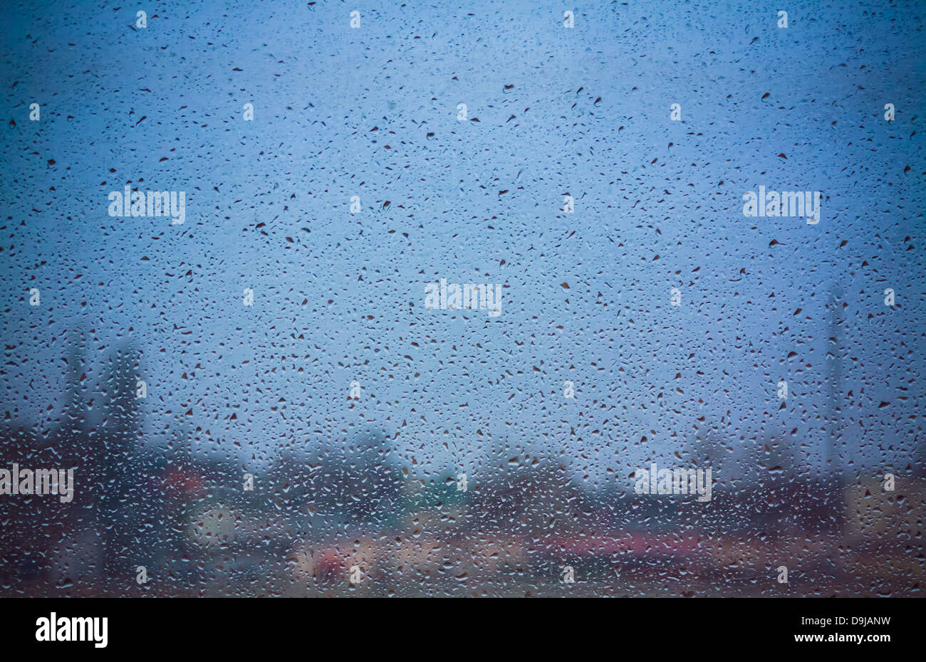 Drops Of Rain On Blue Glass Background Stock Photo - Alamy