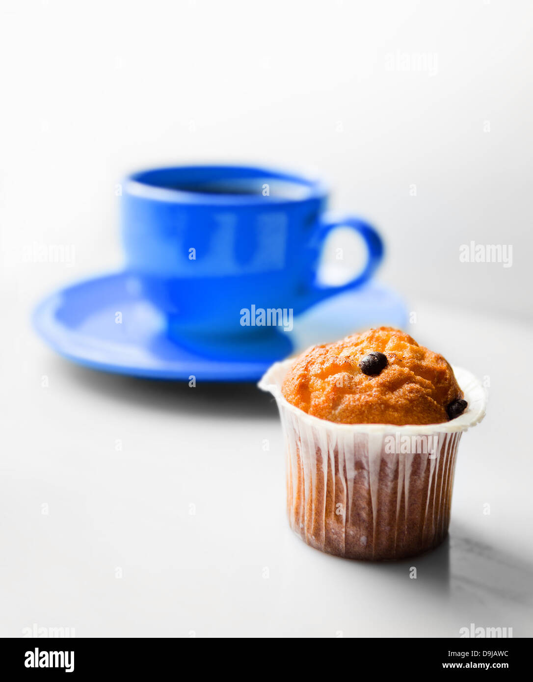 Coffee in a blue cup and a muffin Stock Photo Alamy