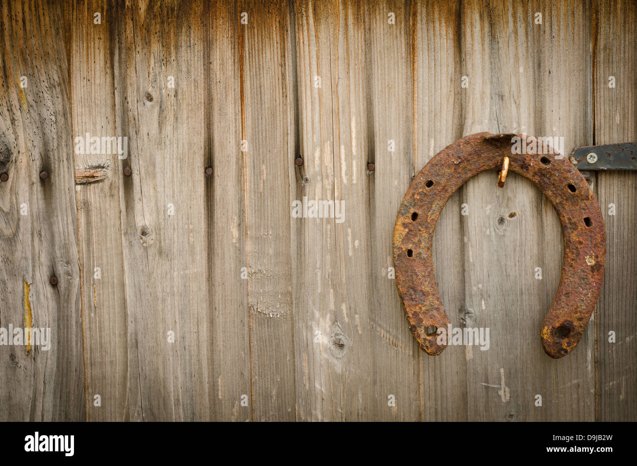 Rusty horseshoe on a wooden barn door Stock Photo Alamy