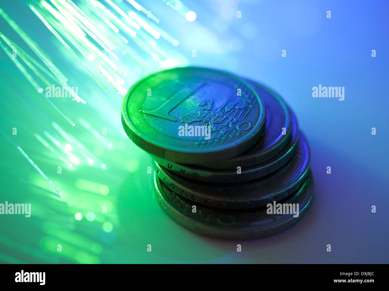 Euro coins on fiber optics background Stock Photo
